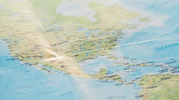 Selective focus of american continents on world map - Point Comfort Group Selective focus of american continents on world map