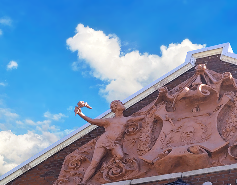 closeup of sculpture at top of point comfort headquarters