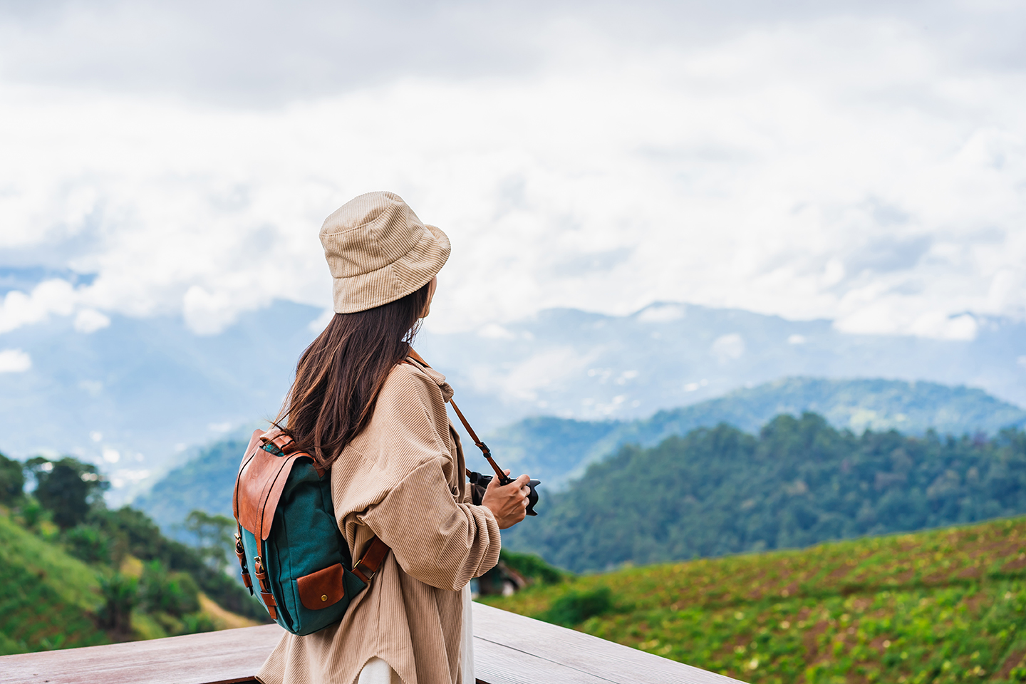 Young woman traveler taking a beautiful landscape at the mountains, Travel lifestyle concept
