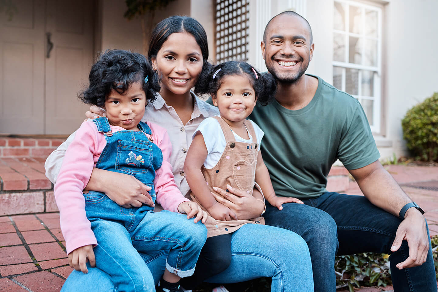 family-sitting-on-front-steps